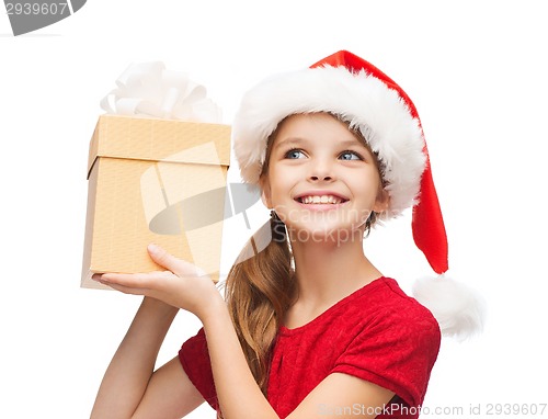 Image of smiling girl in santa helper hat with gift box