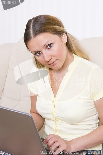 Image of young woman working at laptop