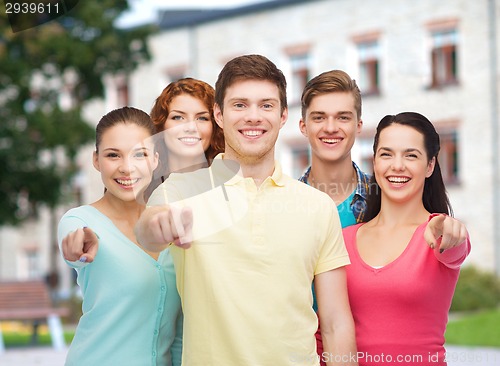 Image of group of smiling teenagers over campus background