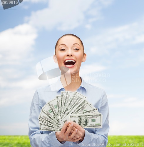 Image of laughing businesswoman with dollar cash money