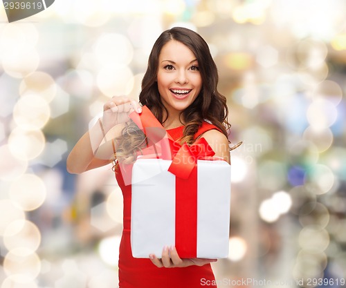 Image of smiling woman in red dress with gift boxes