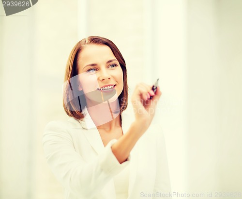 Image of woman writing with pen in the air