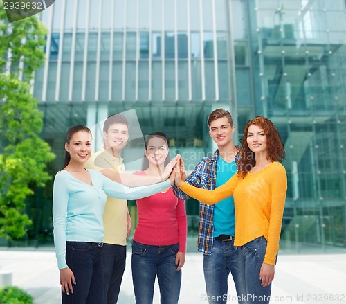 Image of smiling teenagers making high five