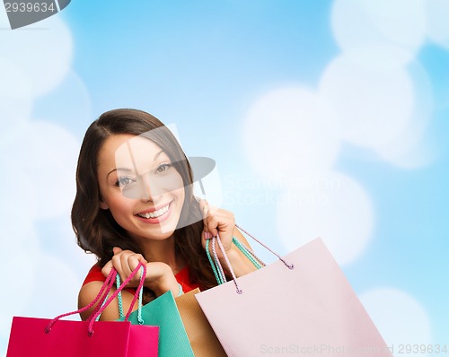 Image of smiling young woman with shopping bags