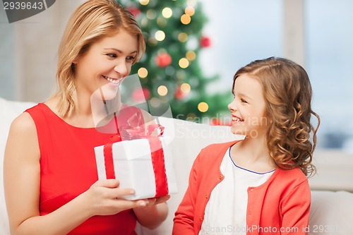 Image of happy mother and child girl with gift box