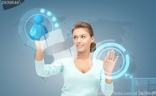 Image of smiling businesswoman working with virtual screen