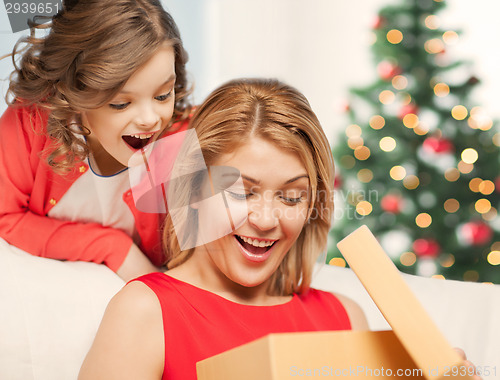 Image of happy mother and child girl with gift box