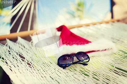 Image of hammock with santa helper hat and shades