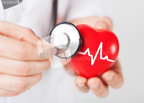 Image of doctor hands holding red heart and stethoscope