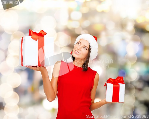 Image of smiling woman in red dress with gift box