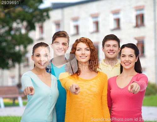 Image of group of smiling teenagers over campus background