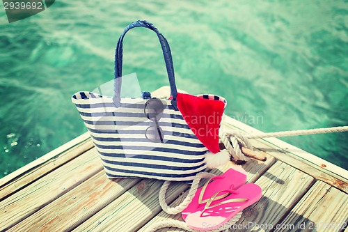 Image of close up of beach accessories and santa helper hat