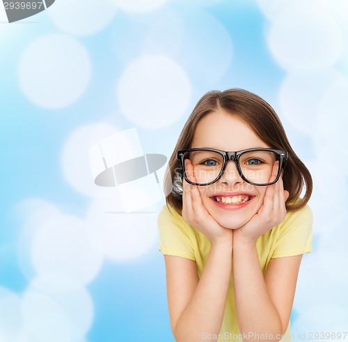 Image of smiling cute little girl in black eyeglasses