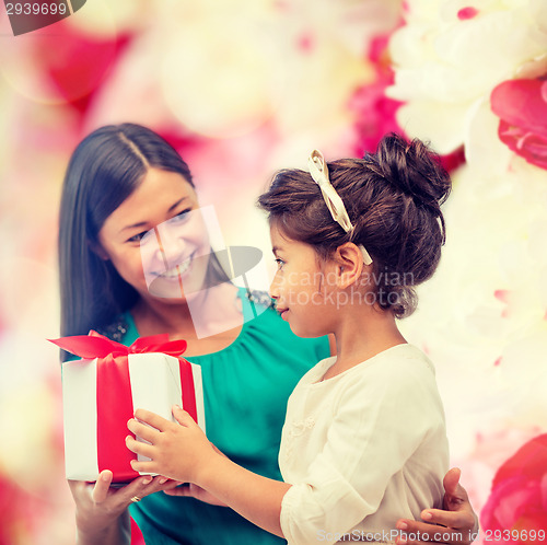 Image of happy mother and child girl with gift box