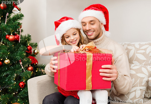 Image of smiling father and daughter opening gift box