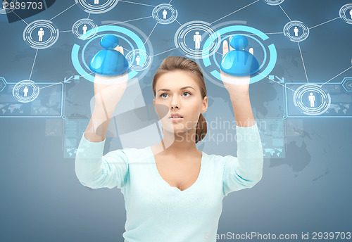 Image of smiling businesswoman working with virtual screen