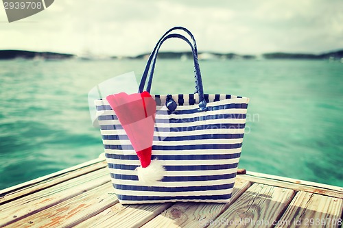 Image of close up of beach bag and santa helper hat