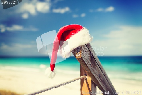 Image of close up of santa helper hat on beach