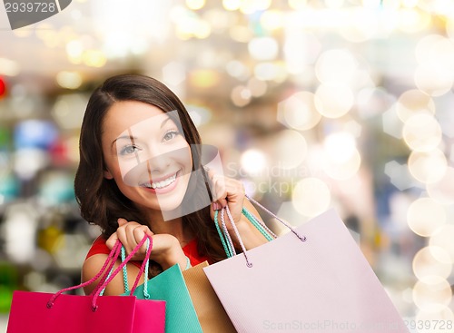 Image of smiling young woman with shopping bags