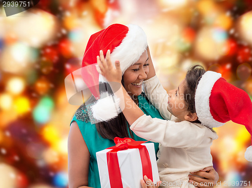 Image of happy mother and child girl with gift box