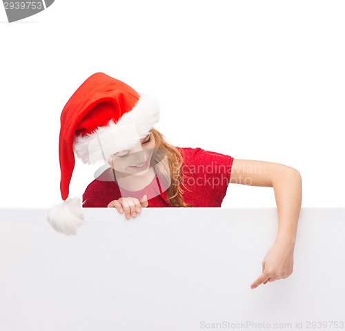 Image of child in santa helper hat with blank white board