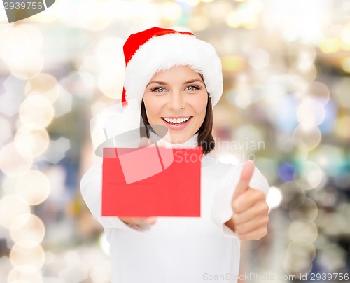 Image of woman in santa helper hat with blank red card