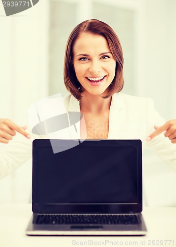 Image of smiling woman with laptop pc