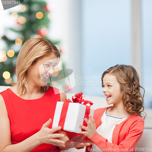 Image of happy mother and child girl with gift box