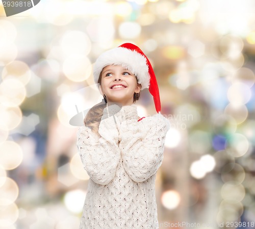 Image of dreaming girl in santa helper hat