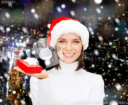 Image of smiling woman in santa helper hat with gift box