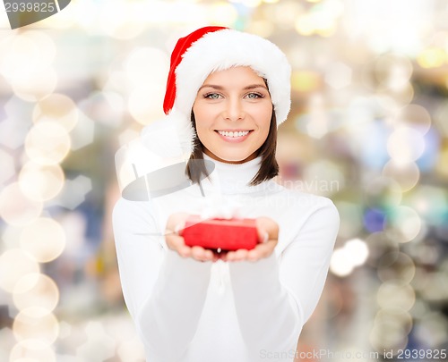 Image of smiling woman in santa helper hat with gift box