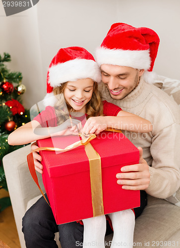 Image of smiling father and daughter opening gift box