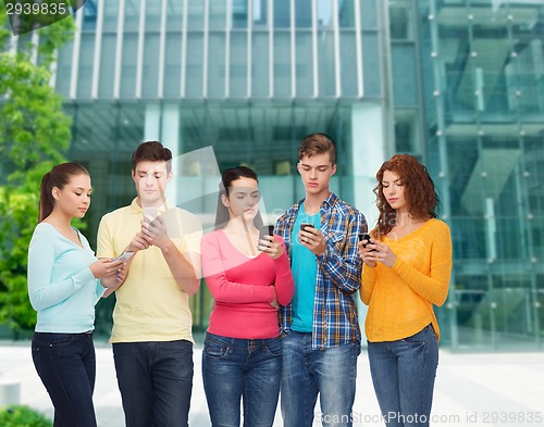Image of group of serious teenagers with smartphones