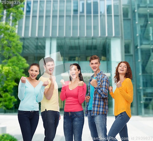 Image of group of smiling teenagers showing triumph gesture