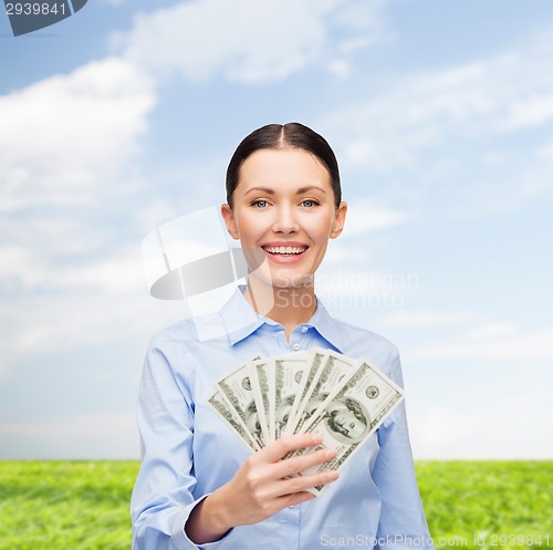 Image of businesswoman with dollar cash money