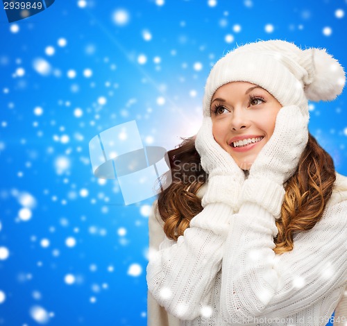 Image of smiling young woman in white winter clothes