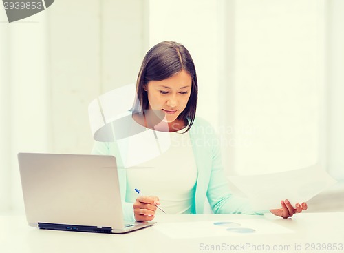 Image of asian businesswoman with laptop and documents