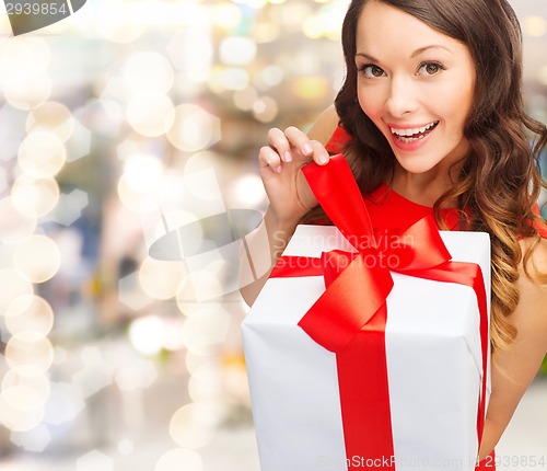 Image of smiling woman in red dress with gift box