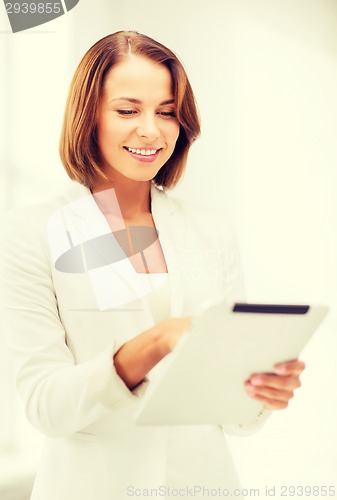 Image of businesswoman with tablet pc in office