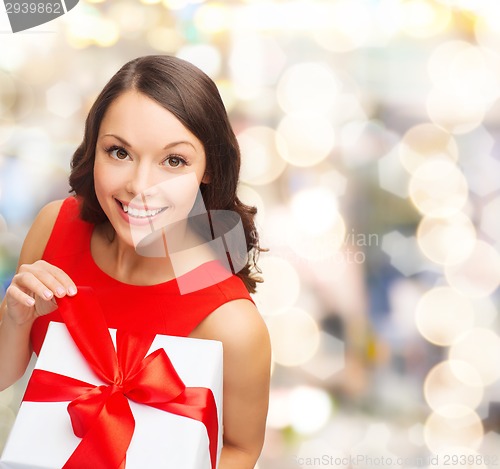 Image of smiling woman in red dress with gift box