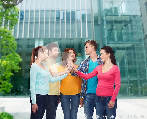 Image of smiling teenagers making high five