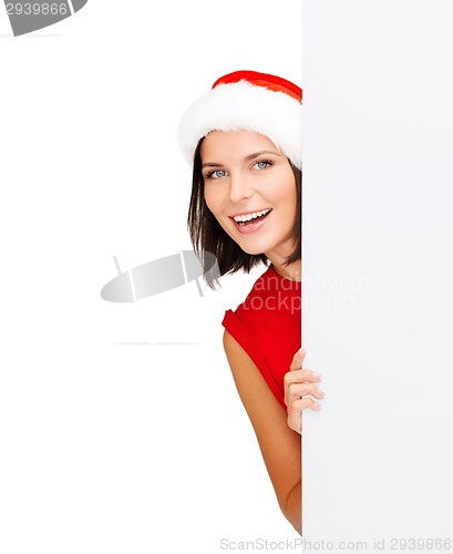 Image of woman in santa helper hat with blank white board