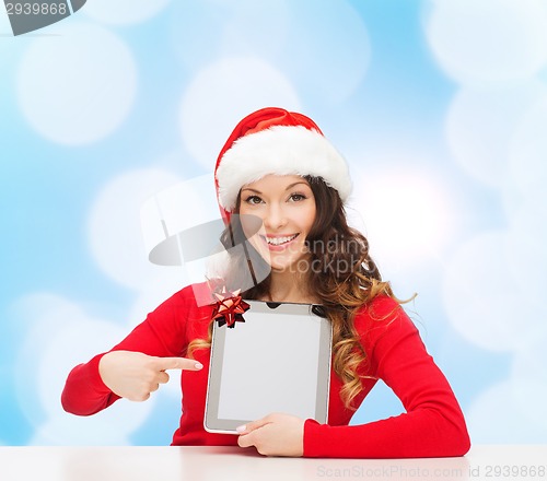 Image of smiling woman in santa hat with gift and tablet pc