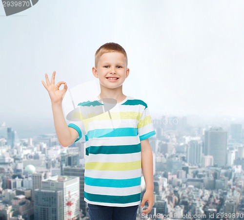 Image of little boy in casual clothes making ok gesture