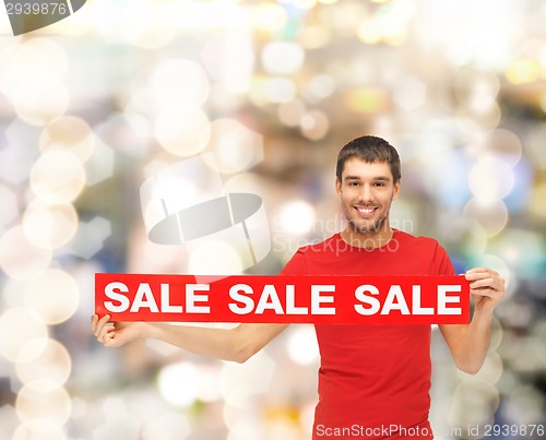 Image of man in red t-shirt with sale sign