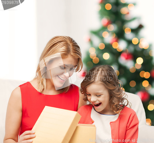 Image of happy mother and child girl with gift box