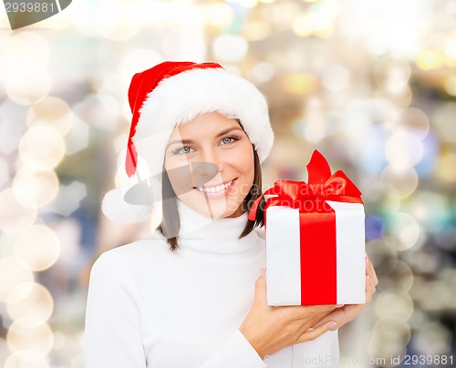 Image of smiling woman in santa helper hat with gift box