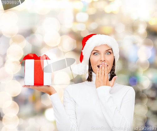 Image of smiling woman in santa helper hat with gift box