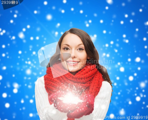 Image of smiling woman in winter clothes with snowflake