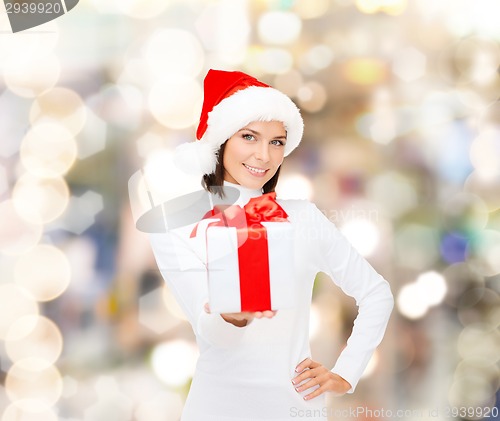 Image of smiling woman in santa helper hat with gift box